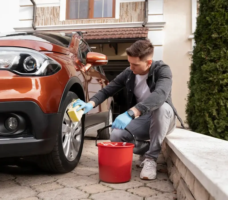 Lavage auto à domicile Fléré-la-Rivière : professionnel intervenant sur un véhicule